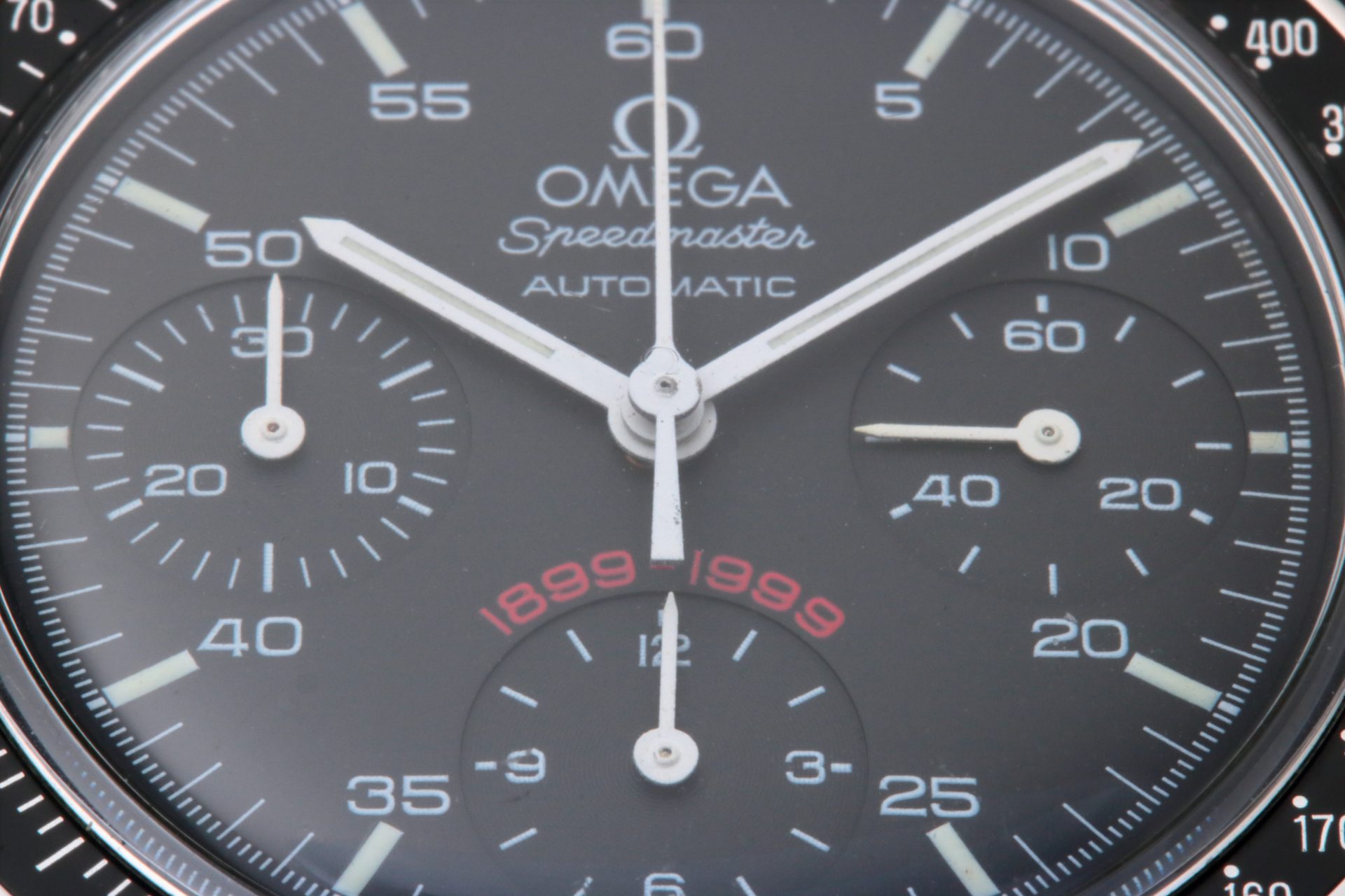 Omega Speedmaster A.C. Milan 1899 - 1999 dial close up of the 3810.51.41. Note the original Omega Hesalite crystal indicated by the Omega logo in the center of the crystal.