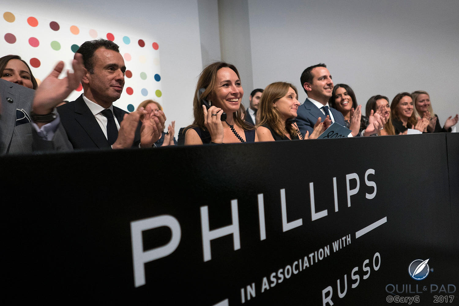Celebration: Nathalie Monbaron (center, on phone) and the Phillips team following the sale of the Paul Newman Rolex Daytona